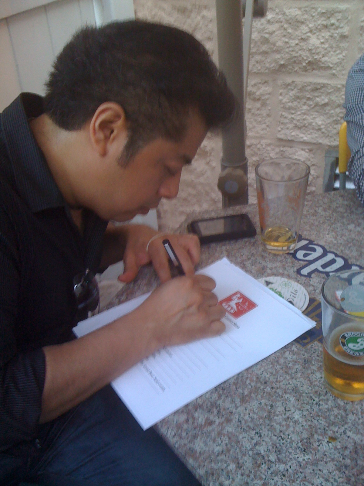 Juan Cruz of Sunswick fills out Good Beer Seal contact sheet at DBA induction ceremony, May 2010
