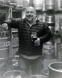 Man at craft beer event tasting beer at WNYC's Greene Space during July Good Beer Month 2011