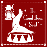 The Good Beer Seal logo featuring a hand holding a beer mug on a red decorative background with ornamental border