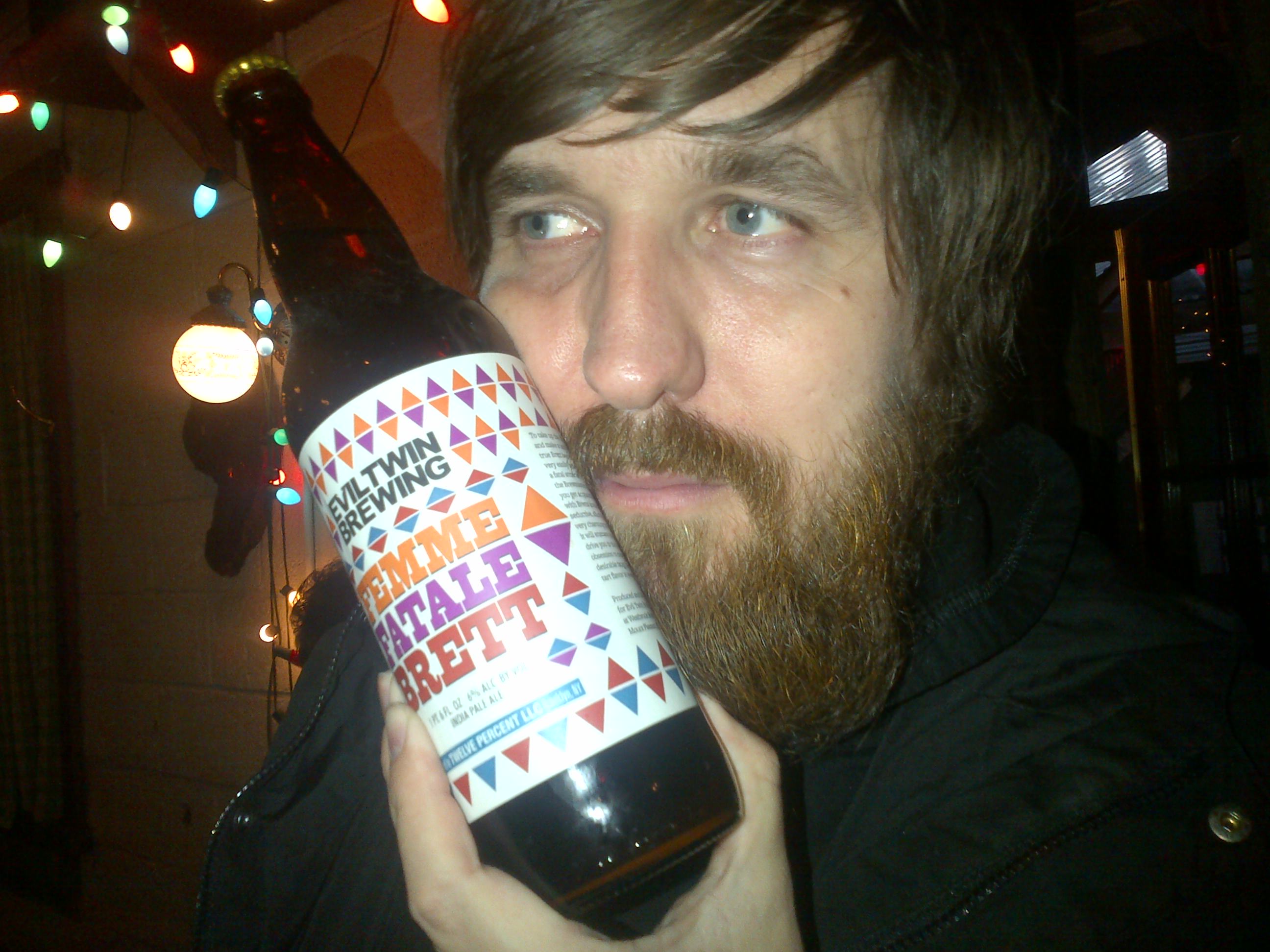 Evil Twin brewer Jeppe Jarnit-Bjergsø holding Biltrawing beer bottle at Beer Sessions Radio, 2013